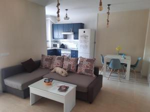 a living room with a couch and a table and a kitchen at La Union in Cuevas del Almanzora