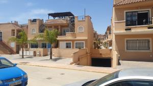 a couple of buildings on the side of a street at La Union in Cuevas del Almanzora