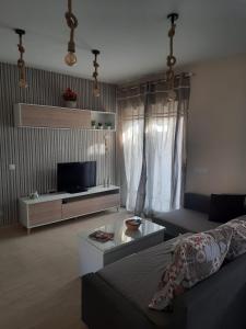 a living room with a couch and a tv at La Union in Cuevas del Almanzora