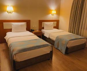 Кровать или кровати в номере Premier Vista Hotel