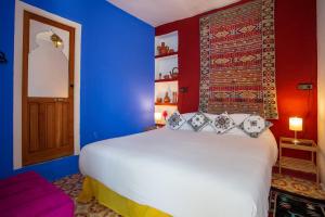 Säng eller sängar i ett rum på Hotel Casa Miguel