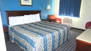 A bed or beds in a room at Budget Host Airport Inn