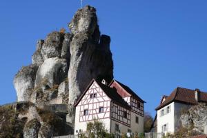 a house in front of a mountain at Limerhof in Waischenfeld