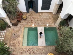 an overhead view of a person in a pool of water at Riad Magellan Yoga and Spa in Marrakesh