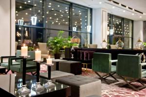 a lobby of a hotel with tables and chairs at Ramada Plaza Hotel & Spa Trabzon in Trabzon