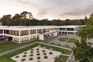 an aerial view of a building with a courtyard at Hotel Dolce La Hulpe Brussels in La Hulpe