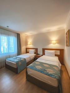 Ένα ή περισσότερα κρεβάτια σε δωμάτιο στο Premier Vista Hotel