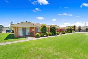 a house with a lawn in front of it at Comfort Inn & Suites King Avenue in Sale