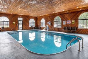 a large swimming pool in a building with a wooden ceiling at Comfort Inn & Suites Napoleon in Napoleon