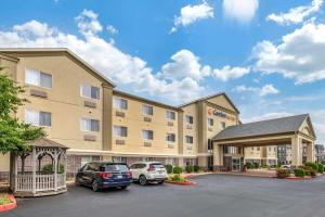 a hotel with two cars parked in a parking lot at Comfort Suites Elkhart North in Elkhart