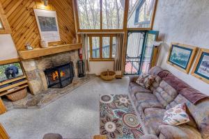 a living room with a couch and a fireplace at Peace, Serenity & Relaxation In The Smokies! in Gatlinburg