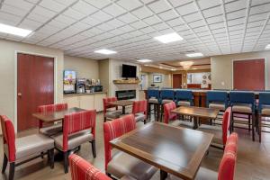 a dining room with tables and chairs at Comfort Inn & Suites in Dayton