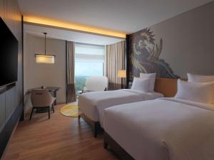 Postel nebo postele na pokoji v ubytování Pullman Bandung Grand Central