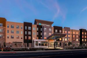 a building with a hotel on the side of a street at Hyatt House Davis in Davis