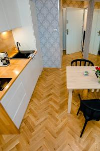 a kitchen and dining room with a table and a counter at Cracovia Wawel Apartments in Kraków