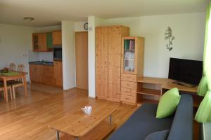 a living room with a couch and a table at Apartma TiJa in Moravske-Toplice