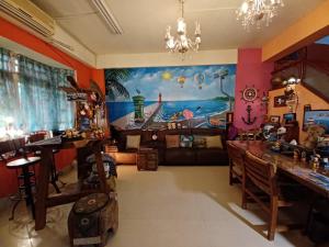 a living room with a painting on the wall at Hualien Seaside B&B in Hualien City