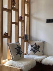 a room with two pillows sitting on a bench at Le terrier in Vaujany