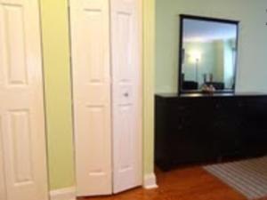 a room with a white door and a mirror at Luxury Studio by Rittenhouse Square in Philadelphia