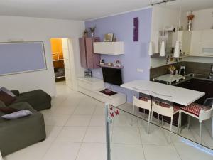 a kitchen and living room with a table and chairs at Memories B&B in Ferrara
