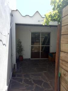 an open garage door with a potted plant in it at alquiler apto. para Brasileros cerca del estadio Centenario, para Conmebol in Montevideo