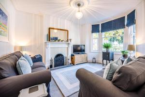 a living room with a couch and a fireplace at Bonheur in Southwold