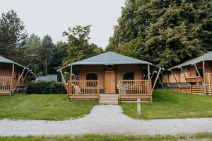 a group of lodges with a tent at Glamping lodge with Eco-Wellness in Zeewolde