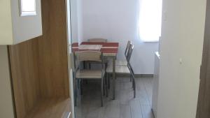 a dining room table and chairs in a room at HZ Apartman Miskolc in Miskolc