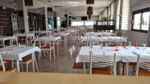 ein Esszimmer mit weißen Tischen und weißen Stühlen in der Unterkunft Hotel Palatinum in Metaponto
