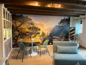 a dining room with a wall mural of a forest at Colombages de la Lauch in Colmar