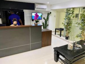 a little boy sitting at a counter in a store at RIG Casa Conde in Santo Domingo +27 photos