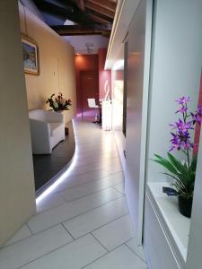 a room with a hallway with a white tile floor at Accomodation Verona - City Centre in Verona