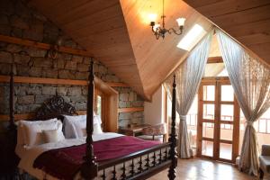 En eller flere senge i et værelse på Kudrat - A Boutique Homestay- Tirthan Valley
