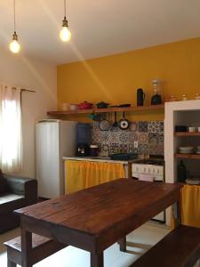 a kitchen with a wooden table in a room at Vila Hibisco Itacaré in Itacaré +133 photos