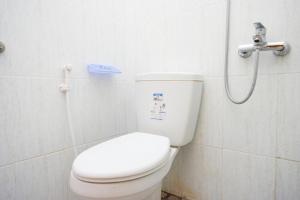 a bathroom with a toilet and a shower at RedDoorz near Sleman City Hall 3 in Yogyakarta +24 photos