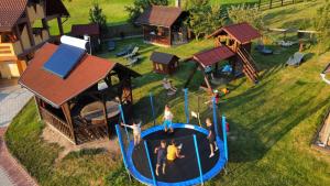 a group of people playing on a playground at Apartamente Manó Apartmanok in Praid