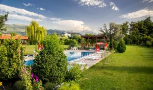 a garden with a swimming pool and a gazebo at Oaza Inn in Ohrid