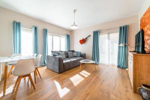a living room with a couch and a table at Komfortowy Apartament w Karpaczu do 5 os. in Karpacz