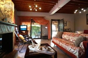 a living room with a couch and a table at Edem Seaside Villa in Paralía Avdhíron