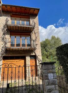 a building with a gate and a balcony at Cal Patola Xic in Bagá