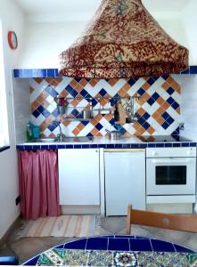 a kitchen with a sink and a stove top oven at L'Antico Frantoio in Rapallo