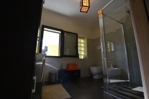 a bathroom with a glass shower and a toilet at B&B Annalu' in Guspini