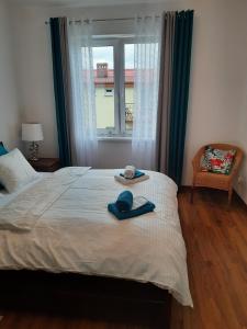 a bed with a hat and a towel on it at Rowy Apartament.b5 in Rowy