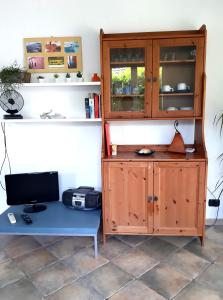 a room with a wooden cabinet and a desk with a computer at L'Antico Frantoio in Rapallo