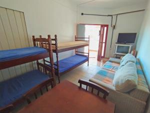 a room with bunk beds and a couch and a tv at Pousada Colibris in Pinhal +76 photos