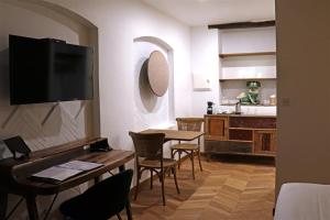 uma sala de estar com uma mesa e uma cozinha em L Amourier chambres d hôtes pour amoureux avec Jacuzzi ou baignoire XXL em Saint-Hippolyte-du-Fort