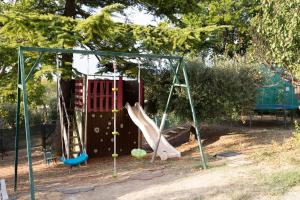 a playground with slides and swings in a park at La Dolce Vallata in Montefiore dellʼAso