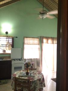 
a kitchen with a table and a window at Antigua Seaview in Saint Johnʼs
