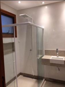 a bathroom with a shower and a sink at Pousada Aromas da Pedra in Pedra Azul