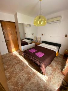 a bedroom with a large bed and a yellow light at Moutallos Rooms Inn Homes in Paphos